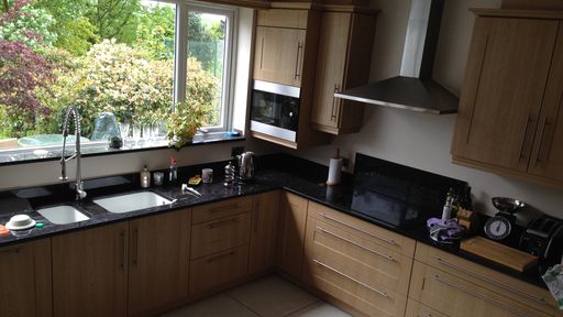 New kitchen fitted, including a double basing sink set within black granite worktops