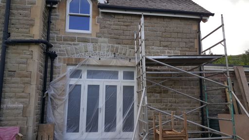 New french doors being installed and repair work being done to the Malvern stone brickwork