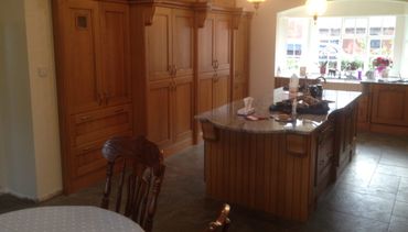 New oak kitchen with central island and food cupboard storage