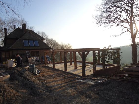 Oak timber pillars erected for a new garage on top of a concrete base