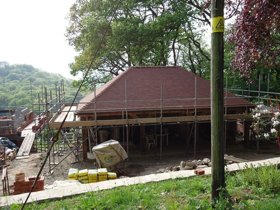 Oak timber pillars erected for a new garage on top of a concrete base