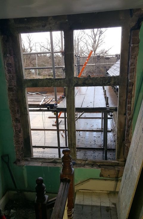 Landing-bay window in a very poor state of disrepair
