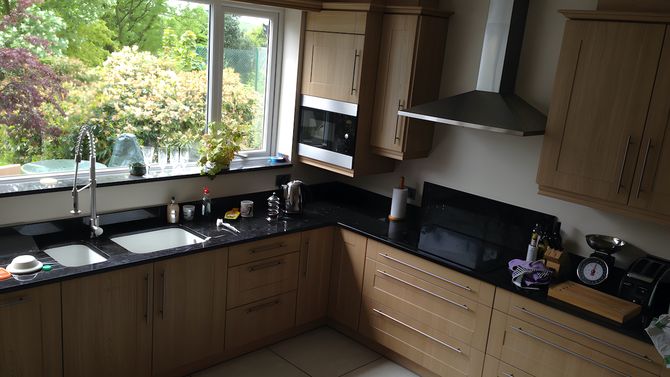 New kitchen fitted, including a double basing sink set within black granite worktops.